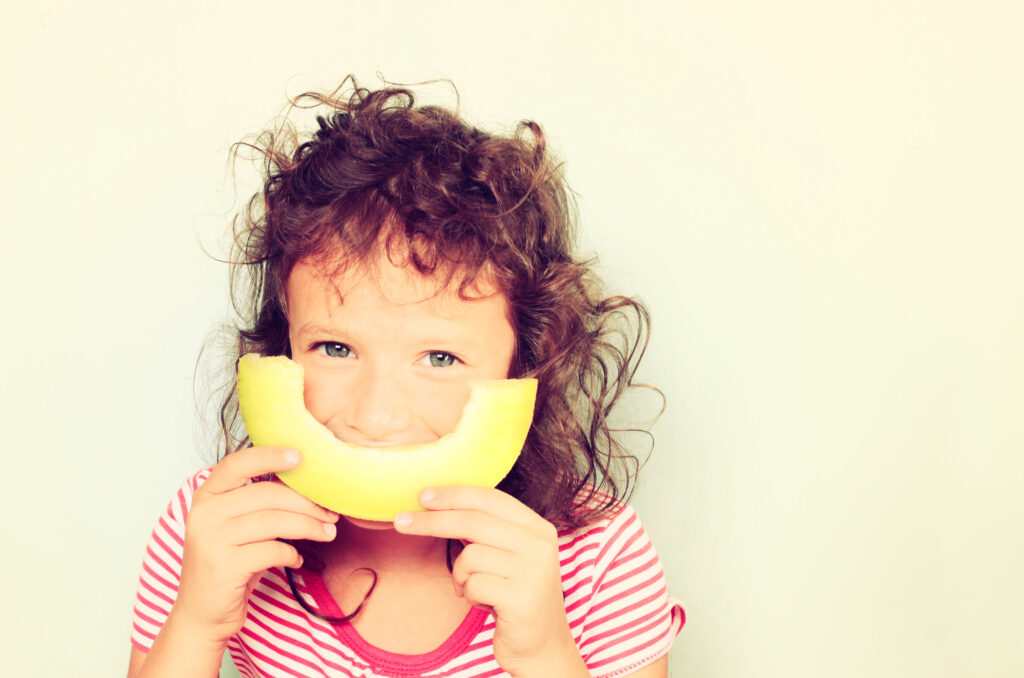 happy child eating melon