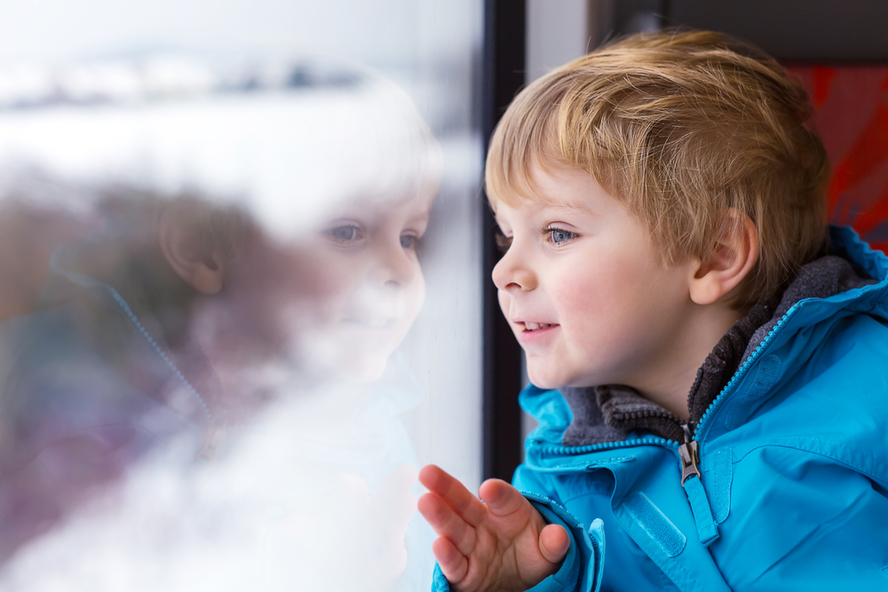 little boy looking out window